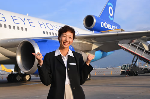 Photo of Mary Lau with Flying Eye Hospital.