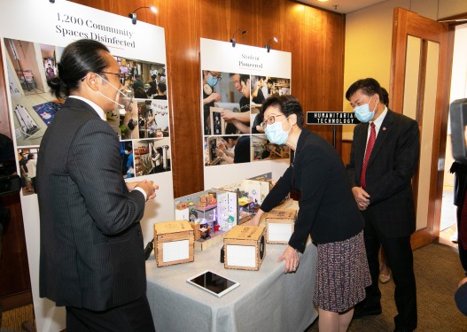 Dr Albert Ko Wing-yin, Director of the Lingnan Entrepreneurship Initiative (left) introduces the low-cost air purifier for subdivided flats invented by LU to the Chief Executive.