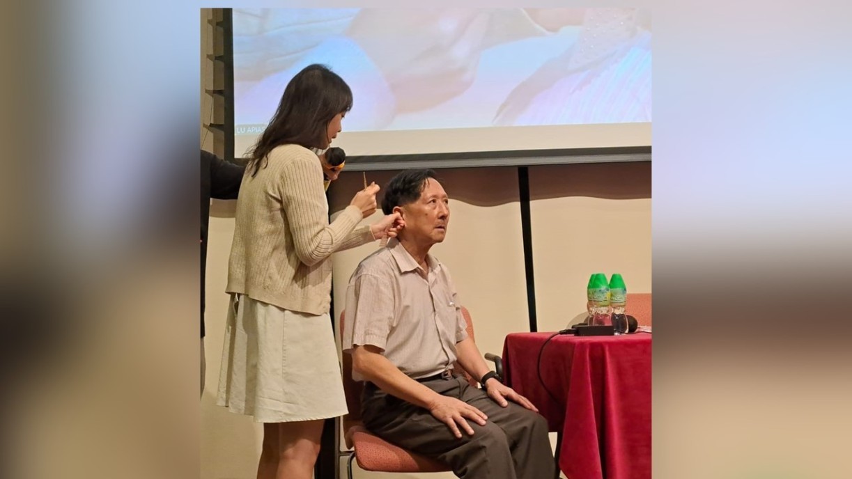 现场观众上台体验耳穴按摩。