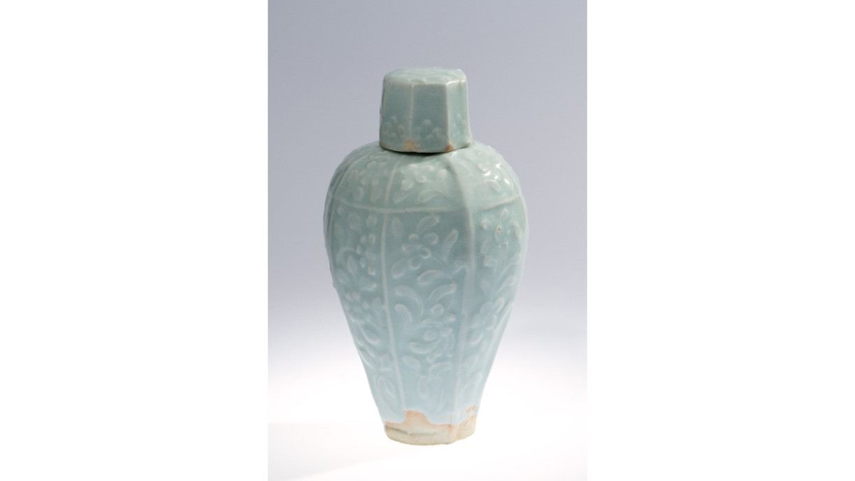 Photo 2. Green and white glazed, lidded, octagonal bottle with plum blossom pattern: Song (960-1279) ; Glazed porcelain;  Dia 32.5 cm H 22.3 cm;  Chamber of Young Snow Collection