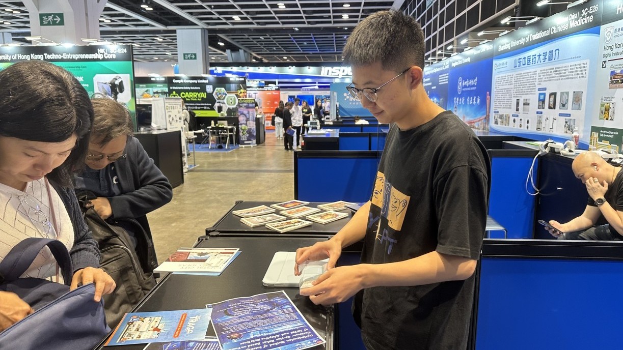 Chang Zhangqi exchanges business cards with visitors.