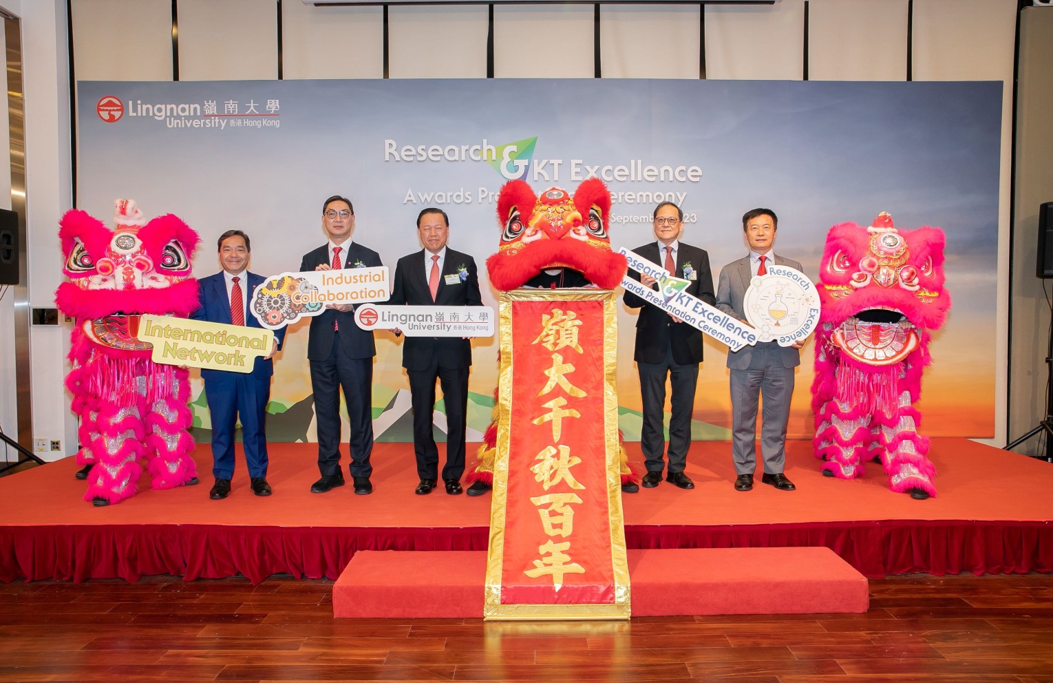 Officiating guests celebrate on stage at the Research and Knowledge Transfer Excellence Awards Presentation Ceremony 2023.