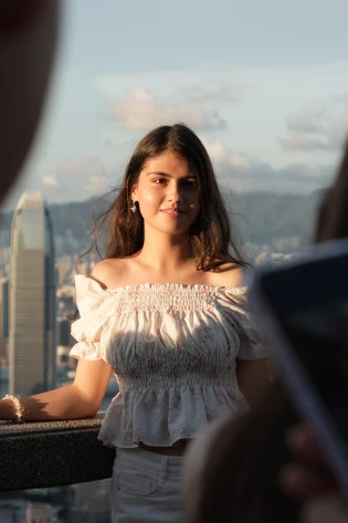 International student from Kazakhstan posing at The Peak with Hong Kong skyline backdrop