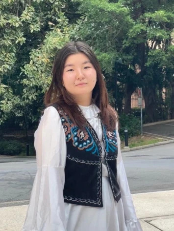 Student from Kyrgyzstan wearing national dress at Lingnan University campus in Hong Kong