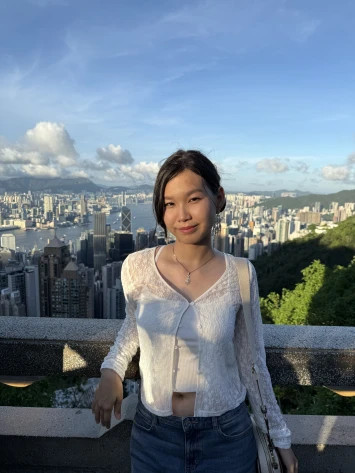 Smiling Russian student posing against Hong Kong skyline view