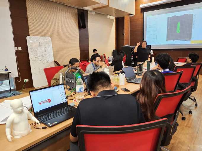  Participants working on laptops during a Humanitarian Technology 3D design workshop.