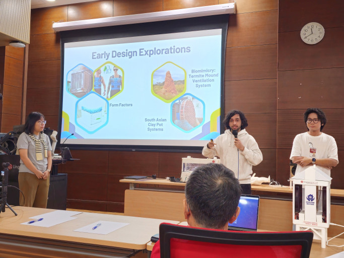  Student team giving a presentation on cooling device design concepts.