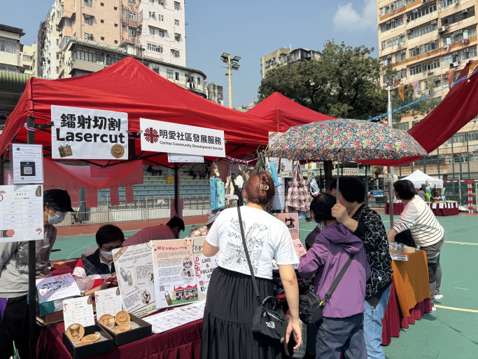   Caritas Community Development Service outdoor laser cutting booth at a street market.