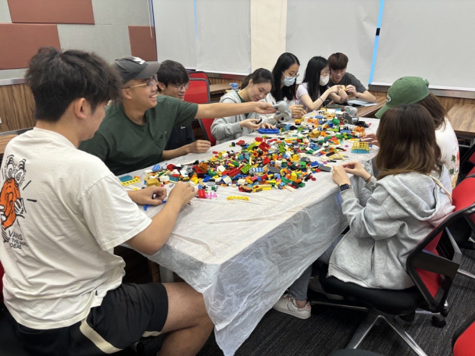HIT Part-time Project Assistants collaborating during a building block prototyping workshop.