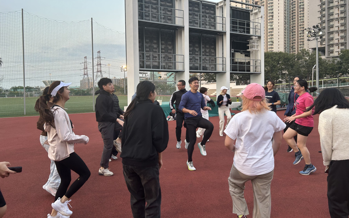 Under professional coaching, participants warm up together.