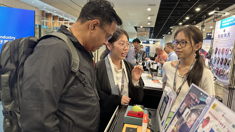 Jenny TANG Jianning and May ZHANG Zhiyu from HAM show visitors the "Echo LInk" smart necklace.