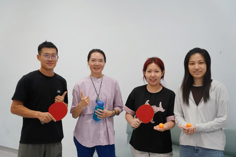PhD students and professors playing table tennis together