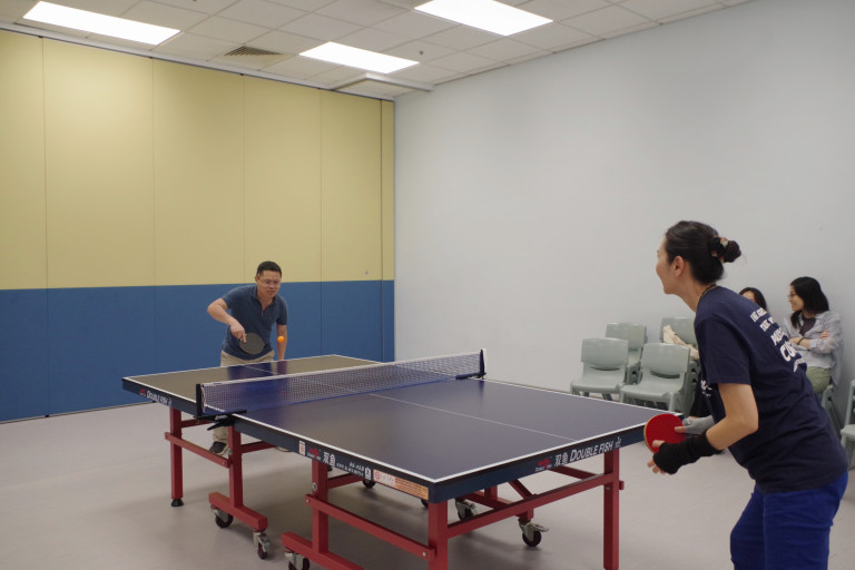PhD students and professors playing table tennis together